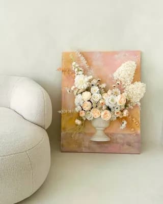 Apricot floral artwork of artificial and preserved flowers in pink and yellow