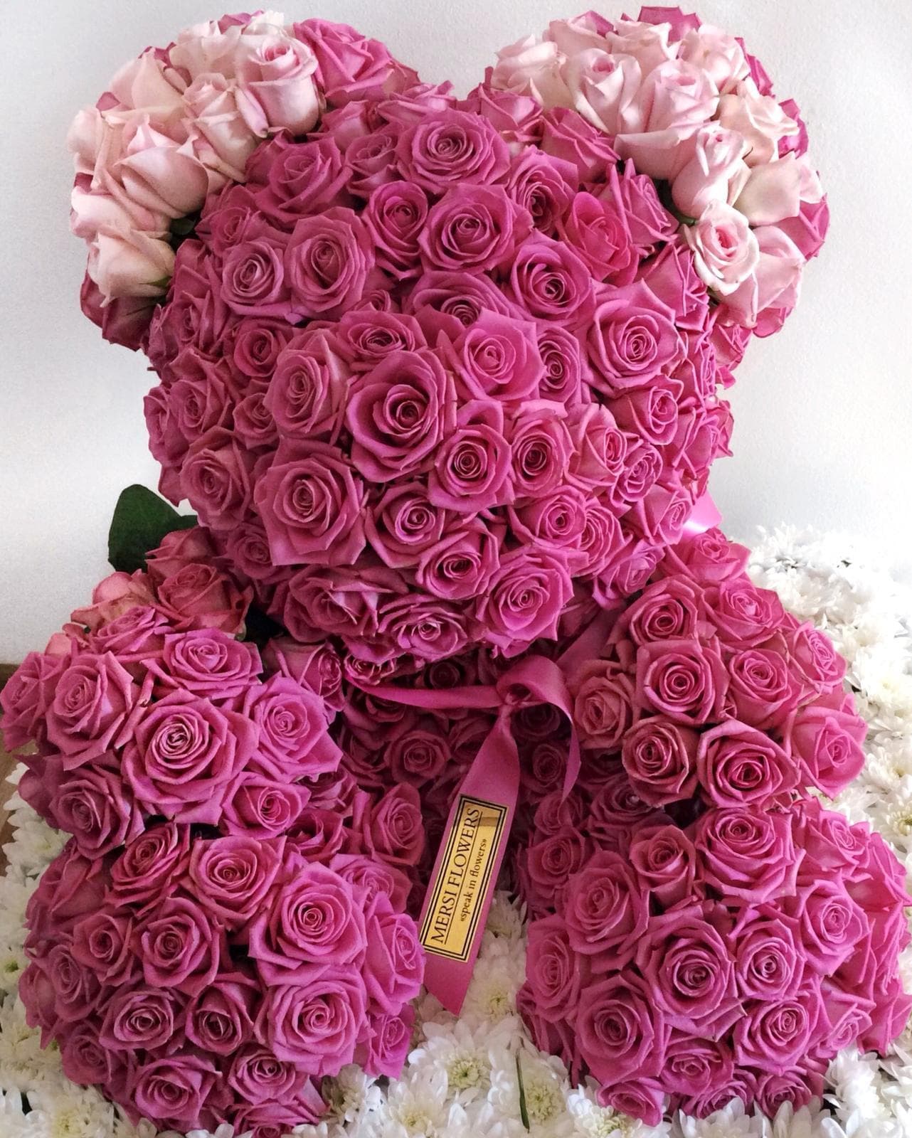 Teddy bear made of real roses on a stand, about 1 metre tall